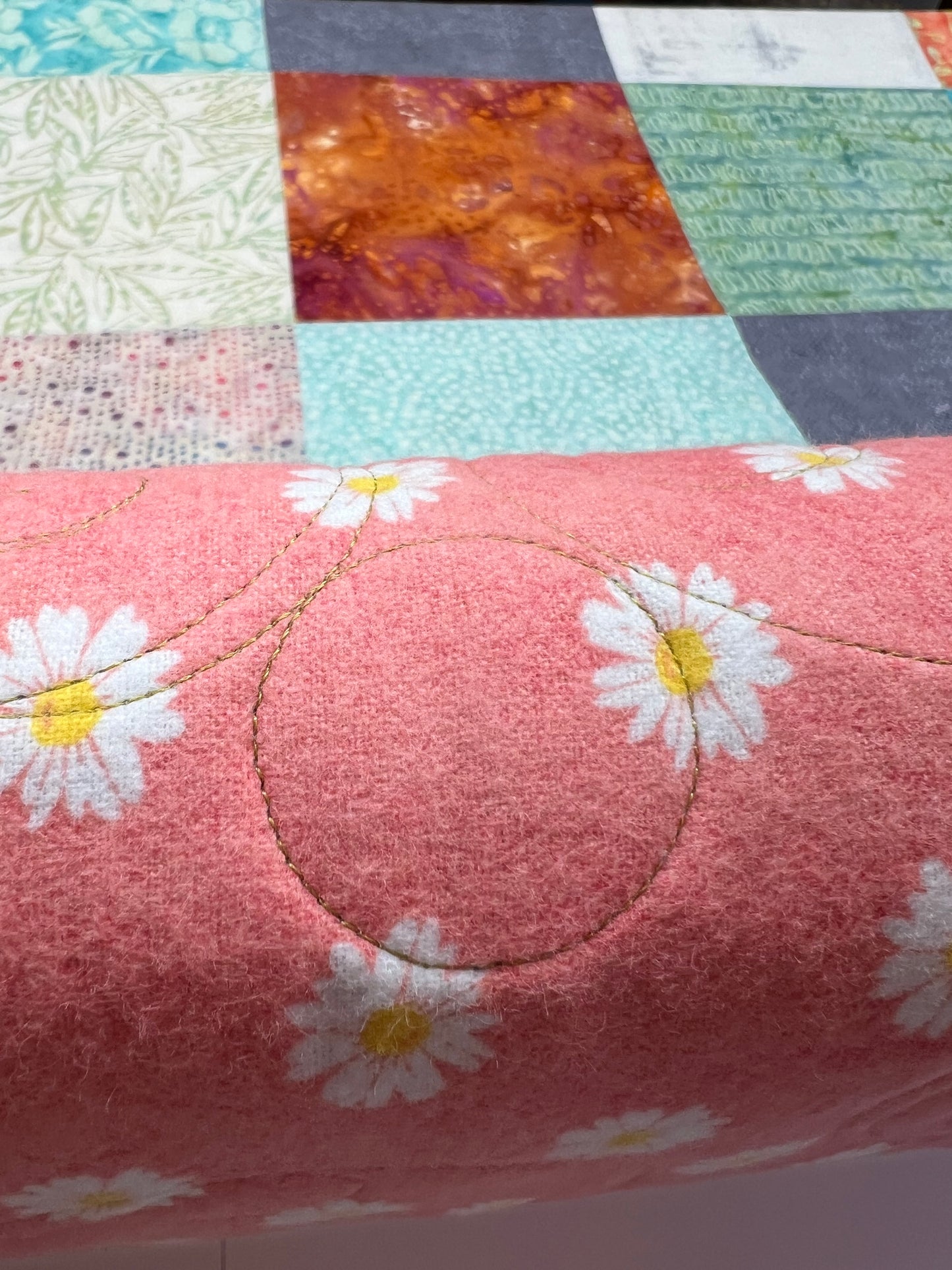 Long arm Quilting for Brenda Hays - Batik quilt with orange border, quilted with daisies and glide, prickly pear thread