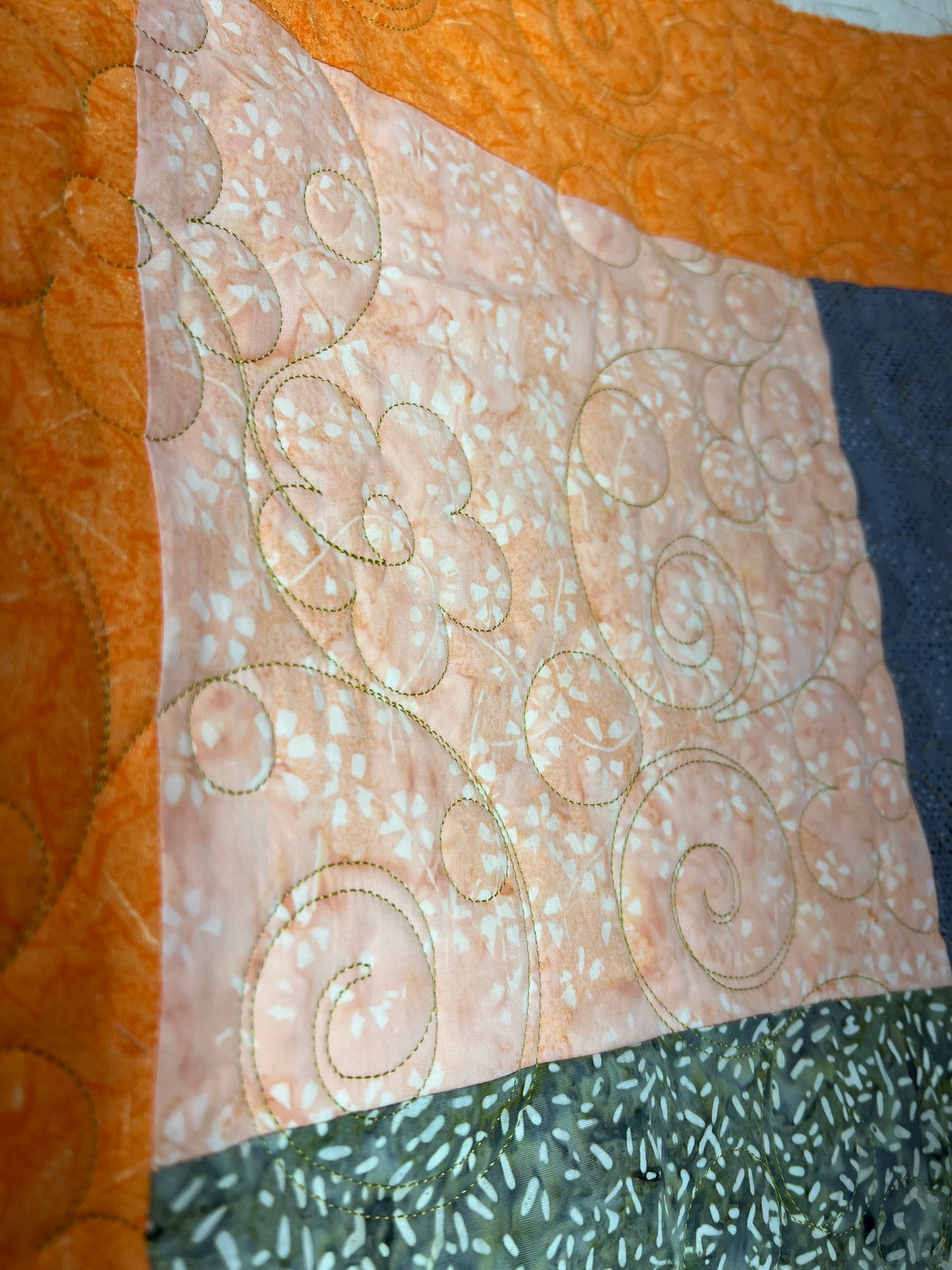 Long arm Quilting for Brenda Hays - Batik quilt with orange border, quilted with daisies and glide, prickly pear thread